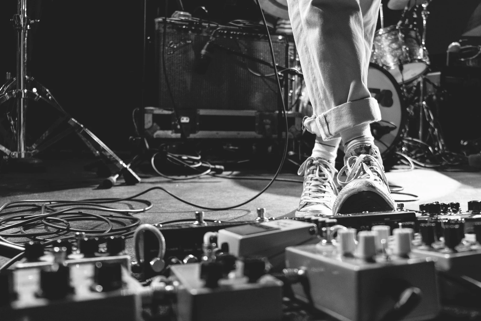 person stepping on guitar distortion. Photograph accompanying Velaharra’s cross-disciplinary creative collaboration guide.