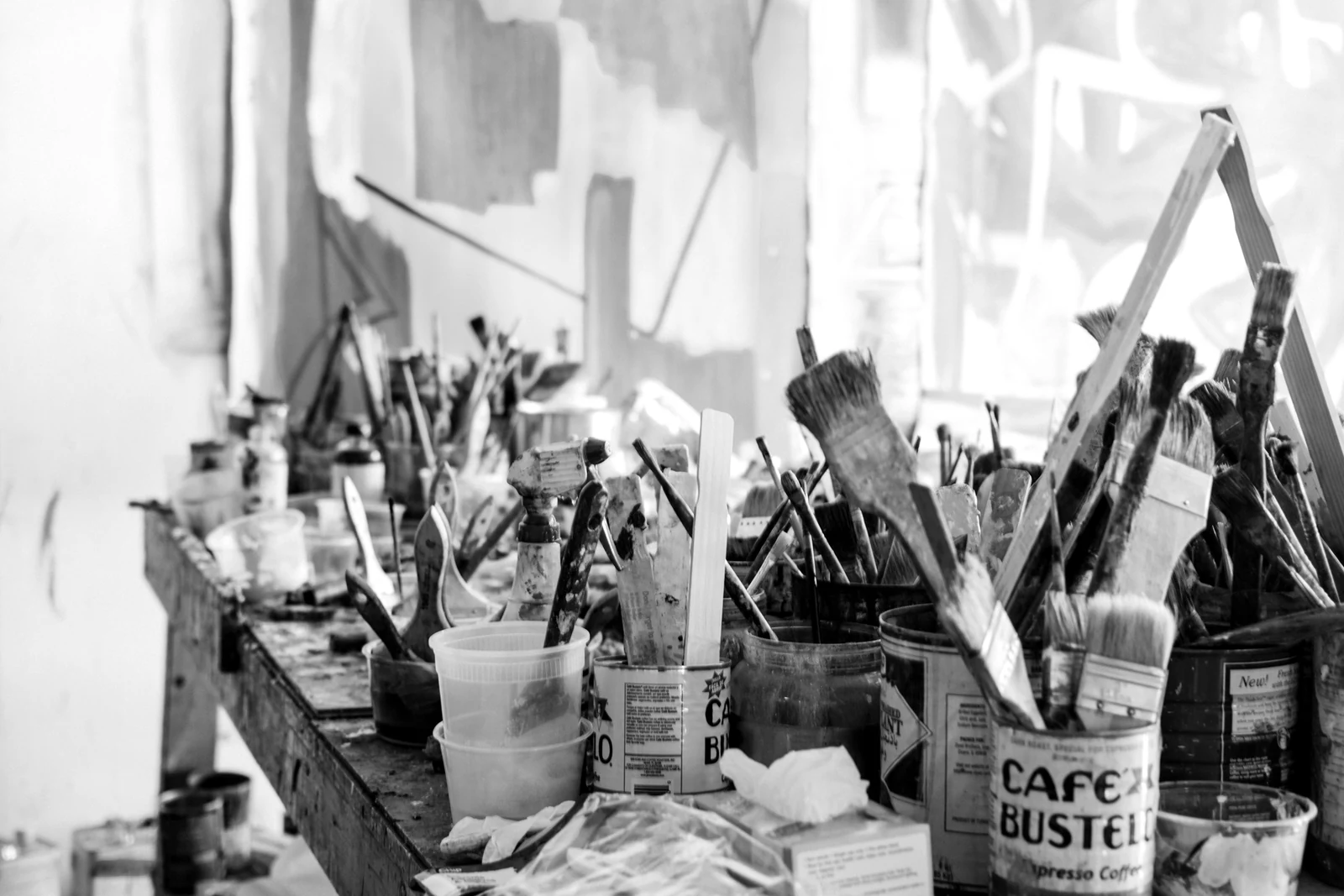 assorted-color paint brush on brown wooden table top. Photograph accompanying Velaharra’s artist sourcing for brands guide.